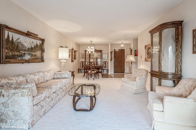 living room with an inviting chandelier and light colored carpet