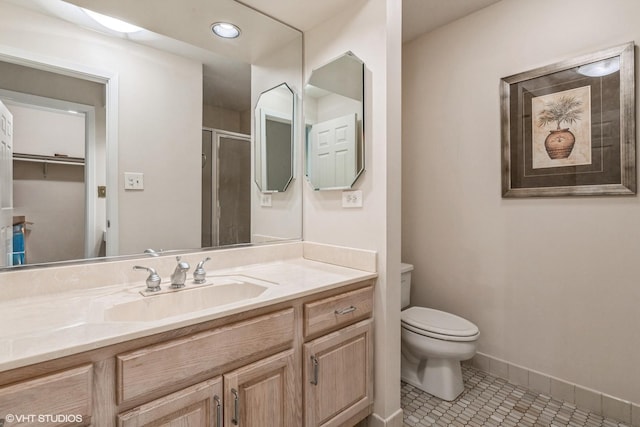 bathroom featuring vanity, toilet, an enclosed shower, and tile patterned flooring