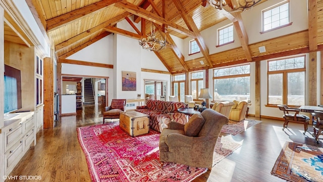 living room with dark hardwood / wood-style flooring, a notable chandelier, and a healthy amount of sunlight