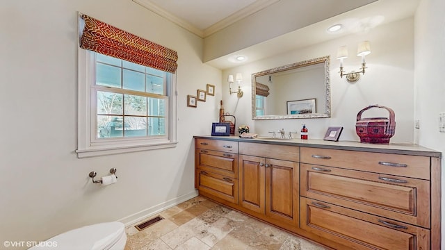 bathroom featuring ornamental molding, vanity, and toilet