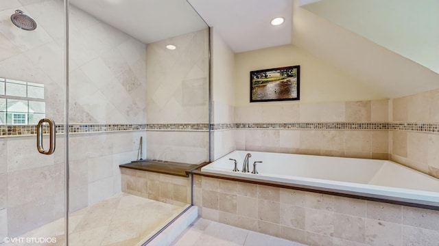 bathroom with vaulted ceiling and shower with separate bathtub