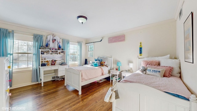 bedroom featuring hardwood / wood-style flooring and crown molding