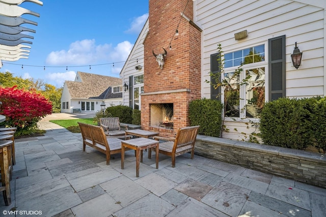 view of patio / terrace with an outdoor brick fireplace