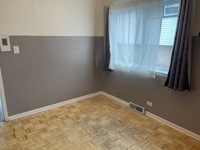 unfurnished room with light parquet flooring