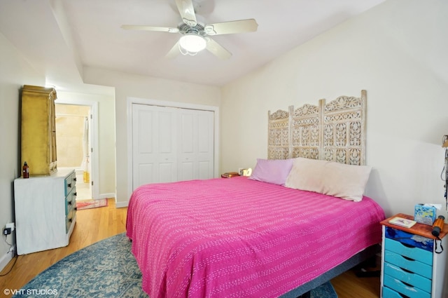 bedroom featuring ceiling fan, light hardwood / wood-style floors, and a closet