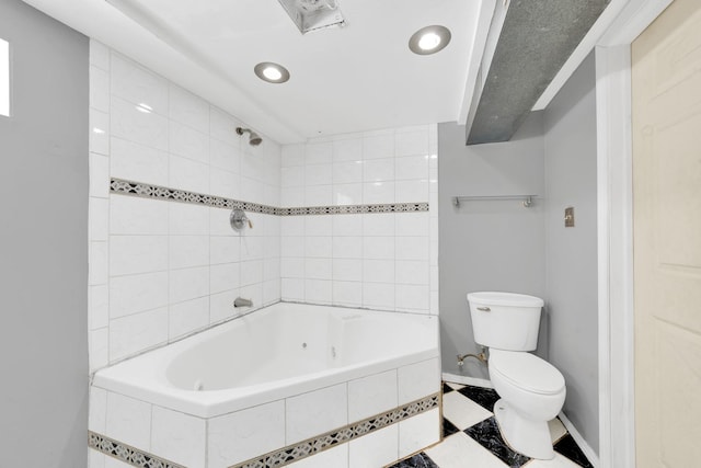 bathroom featuring tiled shower / bath and toilet