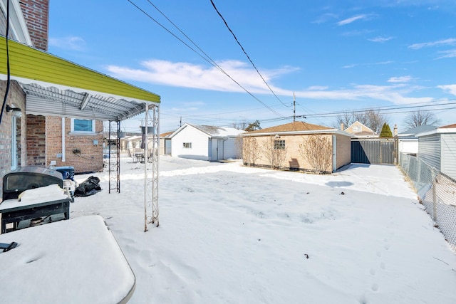 yard layered in snow featuring an outbuilding