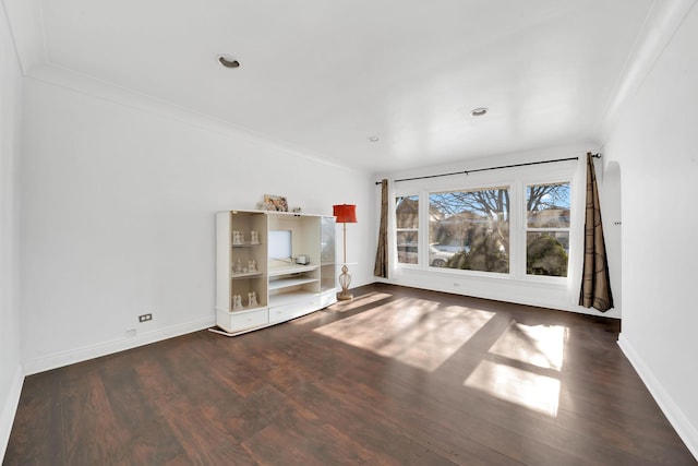 unfurnished living room featuring ornamental molding and dark wood-type flooring