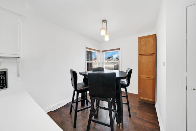 dining space featuring dark wood-type flooring