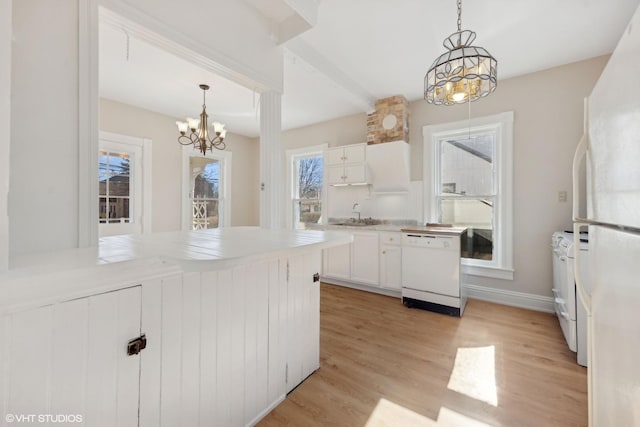 kitchen with hanging light fixtures, an inviting chandelier, white cabinets, and white appliances