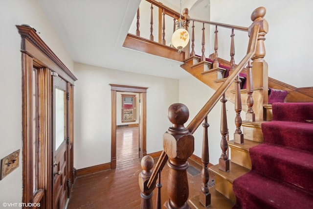 staircase with wood-type flooring