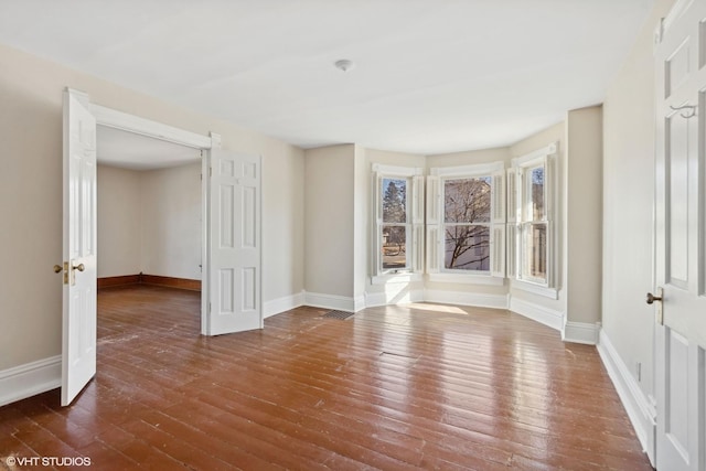 empty room featuring dark wood-type flooring