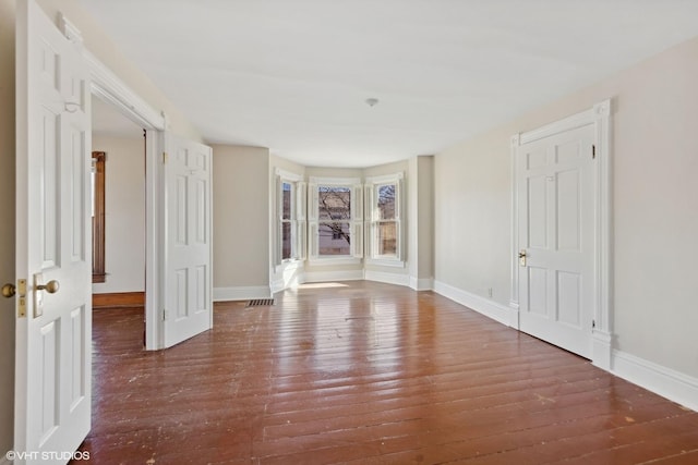 spare room featuring dark wood-type flooring