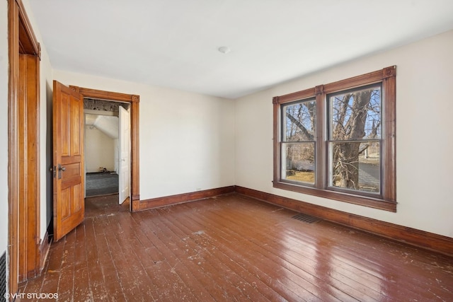 empty room with dark wood-type flooring