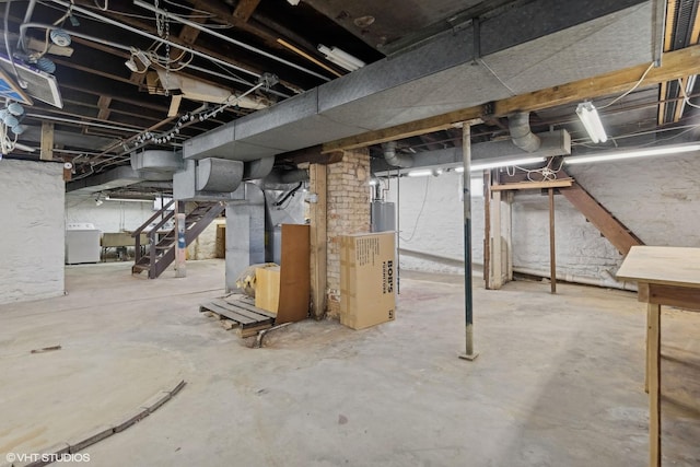 basement featuring gas water heater and washer / dryer