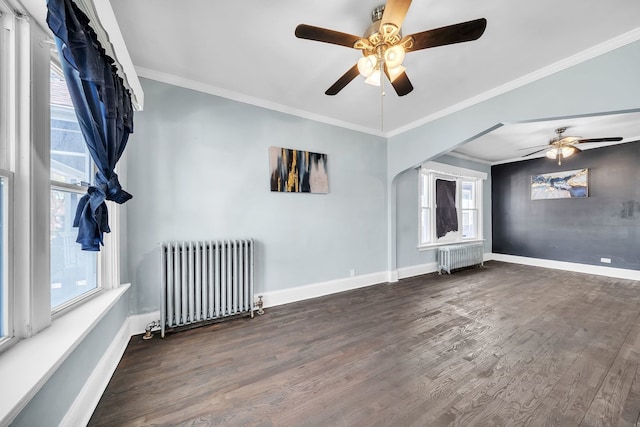 empty room with ornamental molding, dark hardwood / wood-style flooring, and radiator