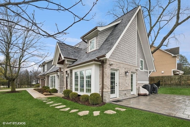 back of house featuring a patio area and a lawn