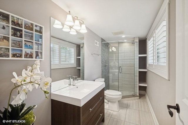 bathroom featuring a shower with door, vanity, a notable chandelier, and toilet