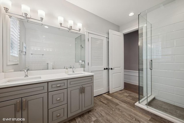 bathroom with vanity, hardwood / wood-style floors, and a shower with shower door