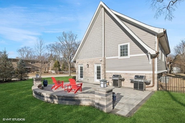 back of house with a yard and a patio