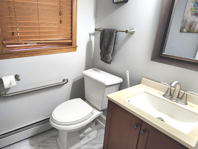 bathroom with vanity, toilet, and baseboard heating