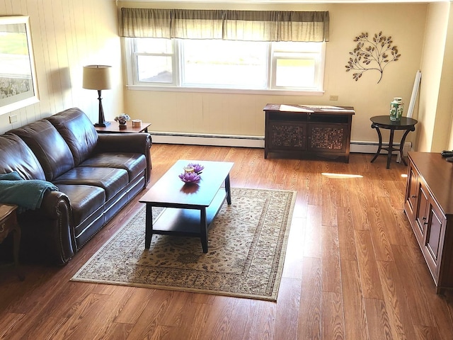 living room featuring a baseboard heating unit and light hardwood / wood-style floors