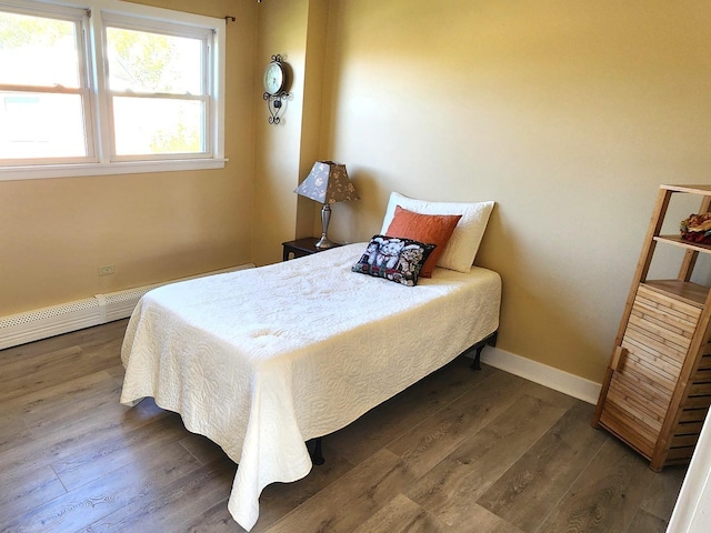 bedroom with dark hardwood / wood-style floors