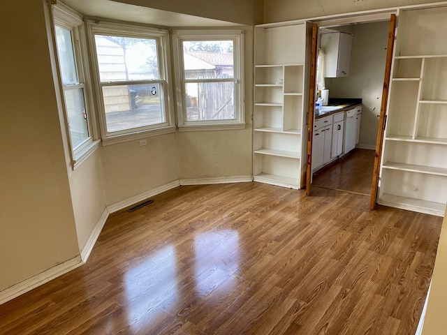 unfurnished dining area with light hardwood / wood-style flooring and a healthy amount of sunlight