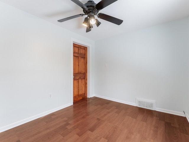 empty room with ceiling fan and hardwood / wood-style floors