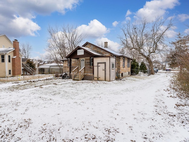 view of snow covered back of property