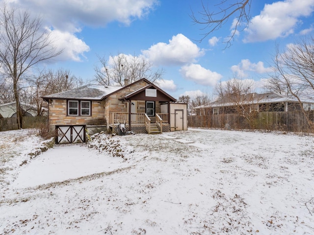 view of snow covered back of property