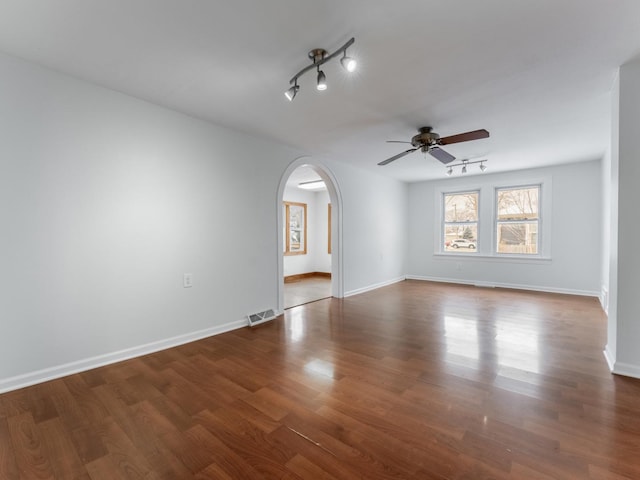 empty room featuring dark hardwood / wood-style floors and ceiling fan