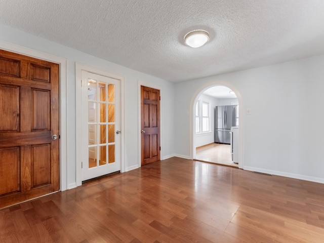 empty room featuring light hardwood / wood-style floors and a textured ceiling