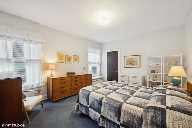 carpeted bedroom featuring radiator