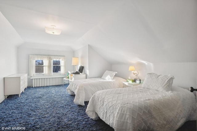 bedroom featuring dark colored carpet, vaulted ceiling, and radiator heating unit