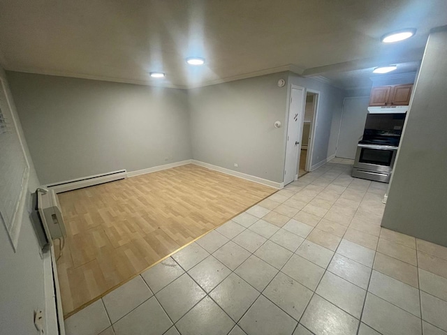 interior space featuring light tile patterned flooring, ornamental molding, and baseboard heating