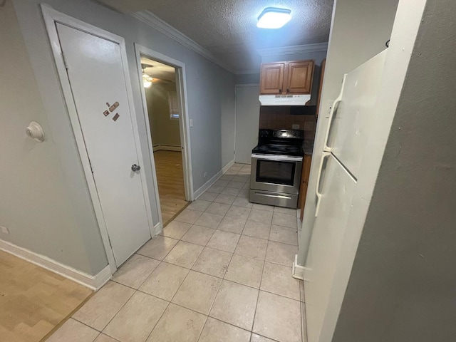 kitchen featuring crown molding, stainless steel electric stove, a textured ceiling, and light tile patterned floors