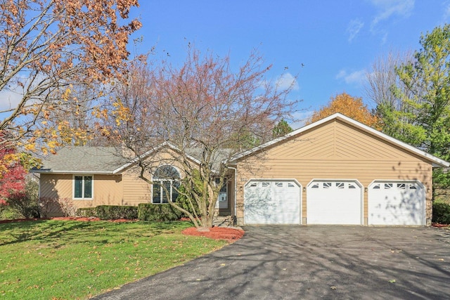 ranch-style home with a garage and a front yard