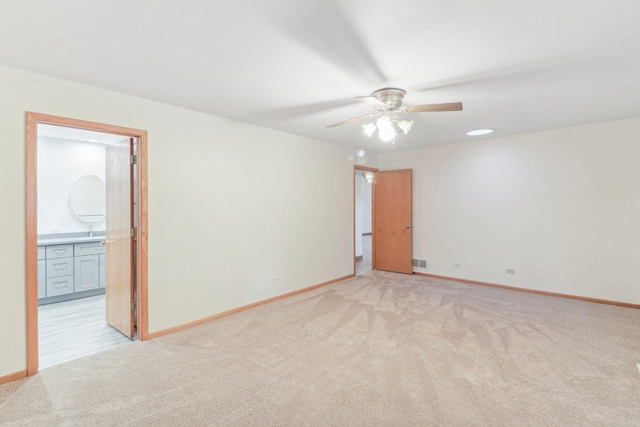 unfurnished room featuring light carpet and ceiling fan