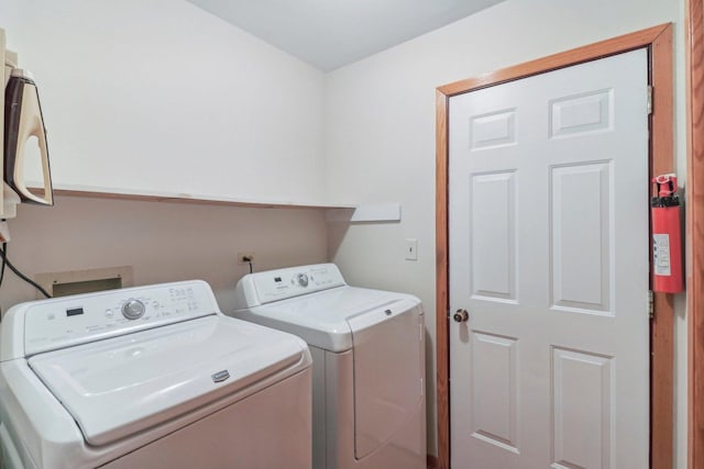 clothes washing area featuring washing machine and clothes dryer