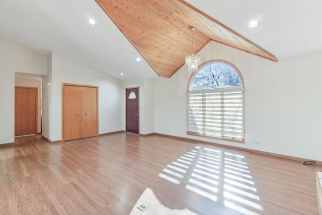 interior space with light hardwood / wood-style flooring, high vaulted ceiling, and a chandelier