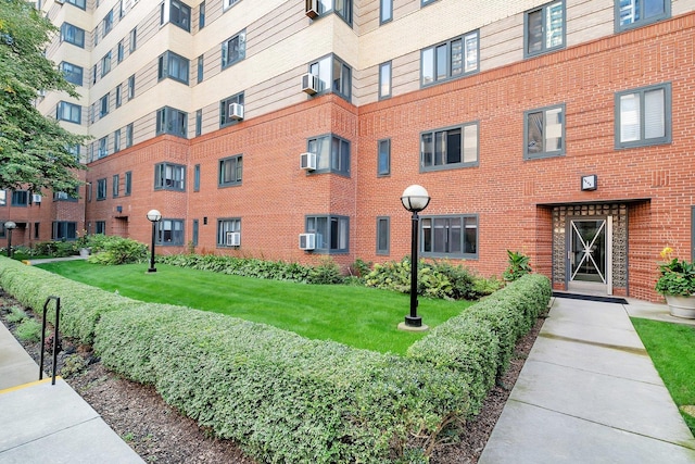 view of building exterior featuring a wall unit AC