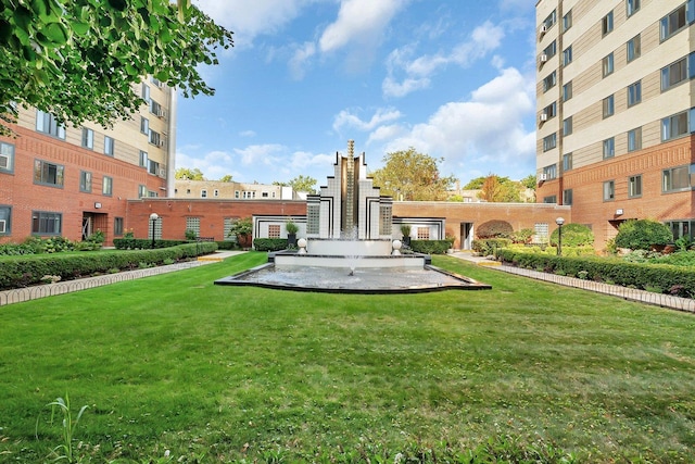 view of home's community with a yard