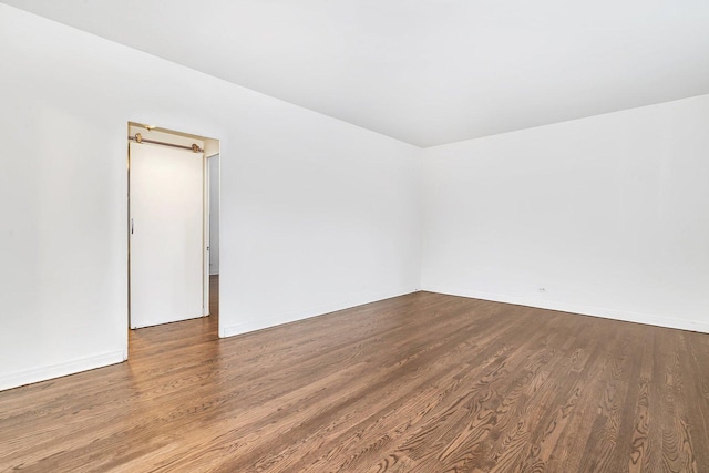 unfurnished room featuring dark hardwood / wood-style flooring