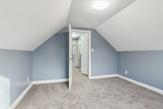 bedroom featuring lofted ceiling and carpet flooring