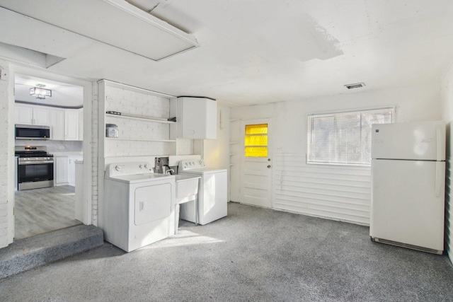 laundry area with independent washer and dryer