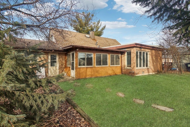 rear view of house featuring a lawn