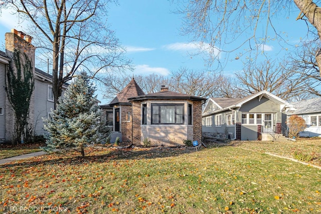 view of side of home with a lawn