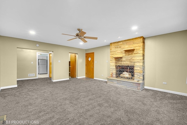 unfurnished living room with ceiling fan, carpet, and a fireplace