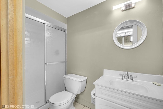 bathroom featuring vanity, tile patterned flooring, toilet, and walk in shower